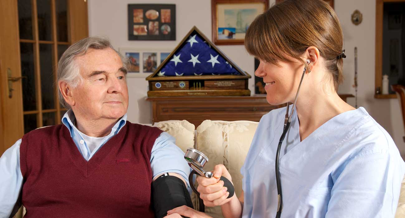 A home health nurse providing skilled in-home nursing for a senior patient in Canton, OH